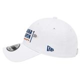 A white baseball cap featuring 'New Orleans' embroidered in navy blue and orange on the side, alongside a small flag patch. The cap also has a navy blue New Era logo on the front and a silver metallic visor sticker.