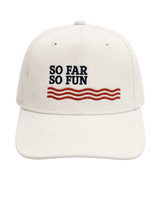 An off-white corduroy baseball cap featuring the embroidered text 'SO FAR SO FUN' in navy blue above three wavy red stripes, set against a solid light beige background.
