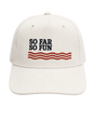 An off-white corduroy baseball cap featuring the embroidered text 'SO FAR SO FUN' in navy blue above three wavy red stripes, set against a solid light beige background.